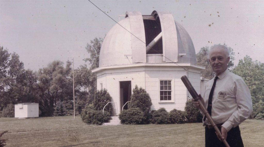 Leslie Peltier with his strawberry spyglass, Miami University observatory and in the far rear the Merry Go Round Observatory
